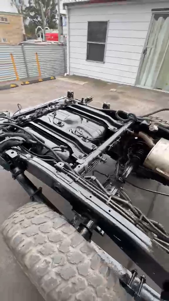 Clean gloss black chassis rail and cross members on an ex-mine LandCruiser 70 Series after dry ice blasting