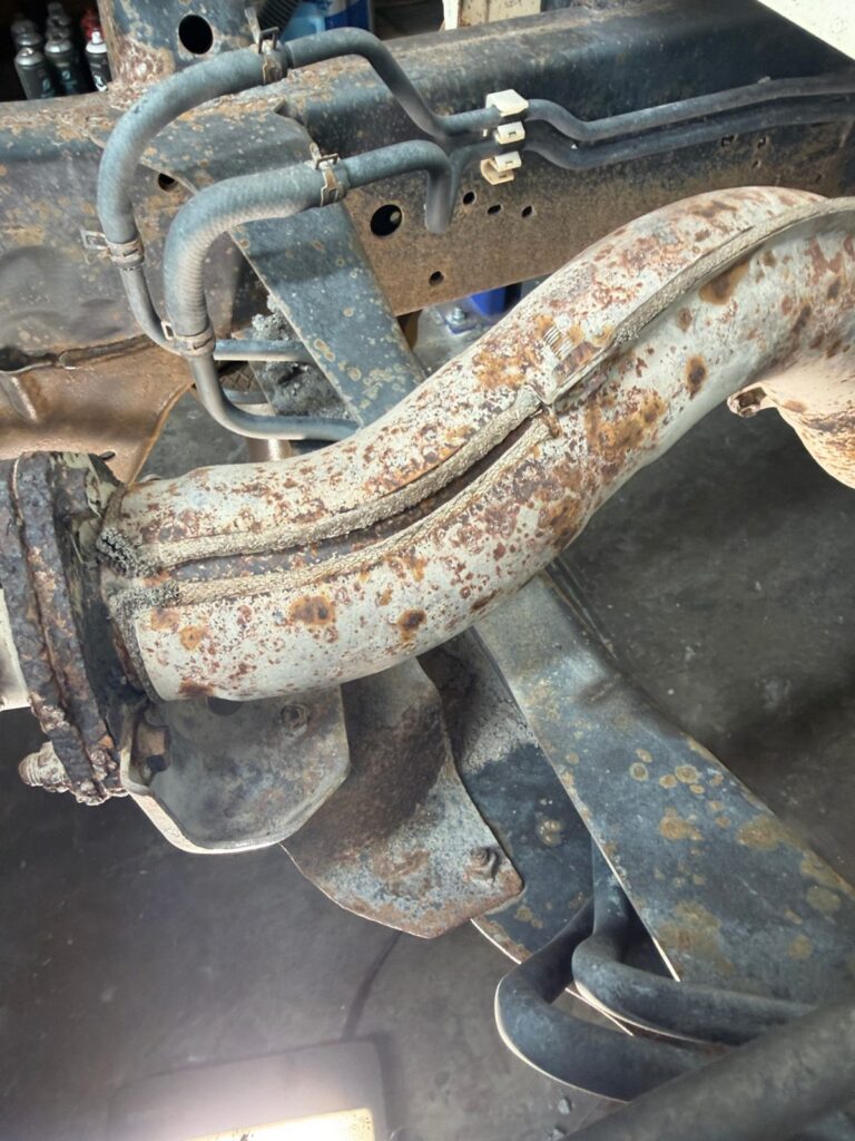 Corroded coil spring on an ex-mine LandCruiser before dry ice blasting and rust treatment